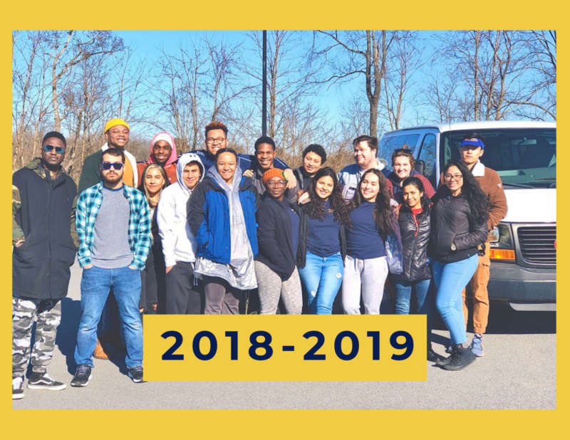 yellow background, in the center is an image of a group of students standing side by side next to a van, and in the bottom center reads "2018-2019"