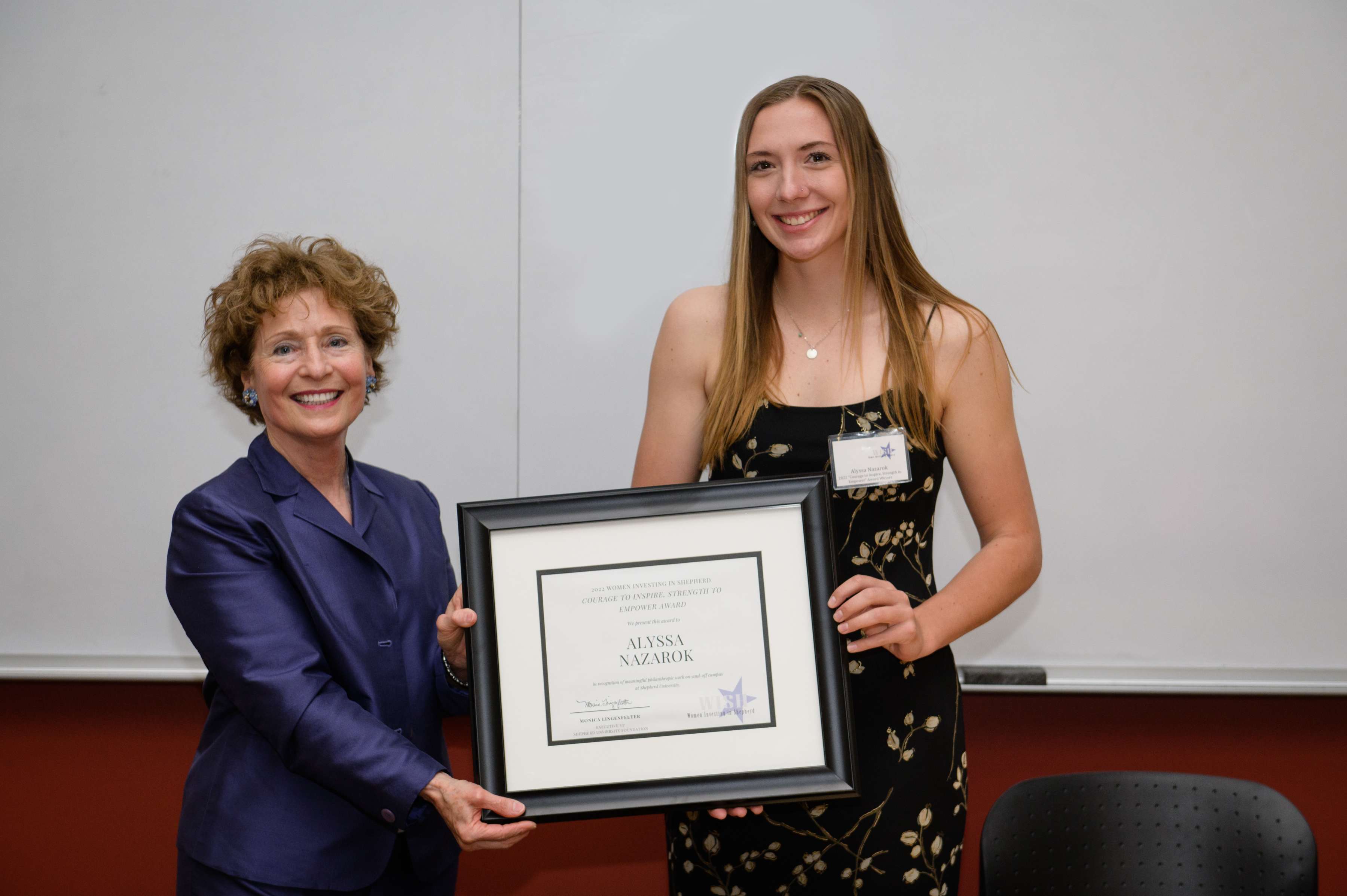 Photo of Dr. Mary J.C. Hendrix with Alyssa Nazarok holding a framed certificate.