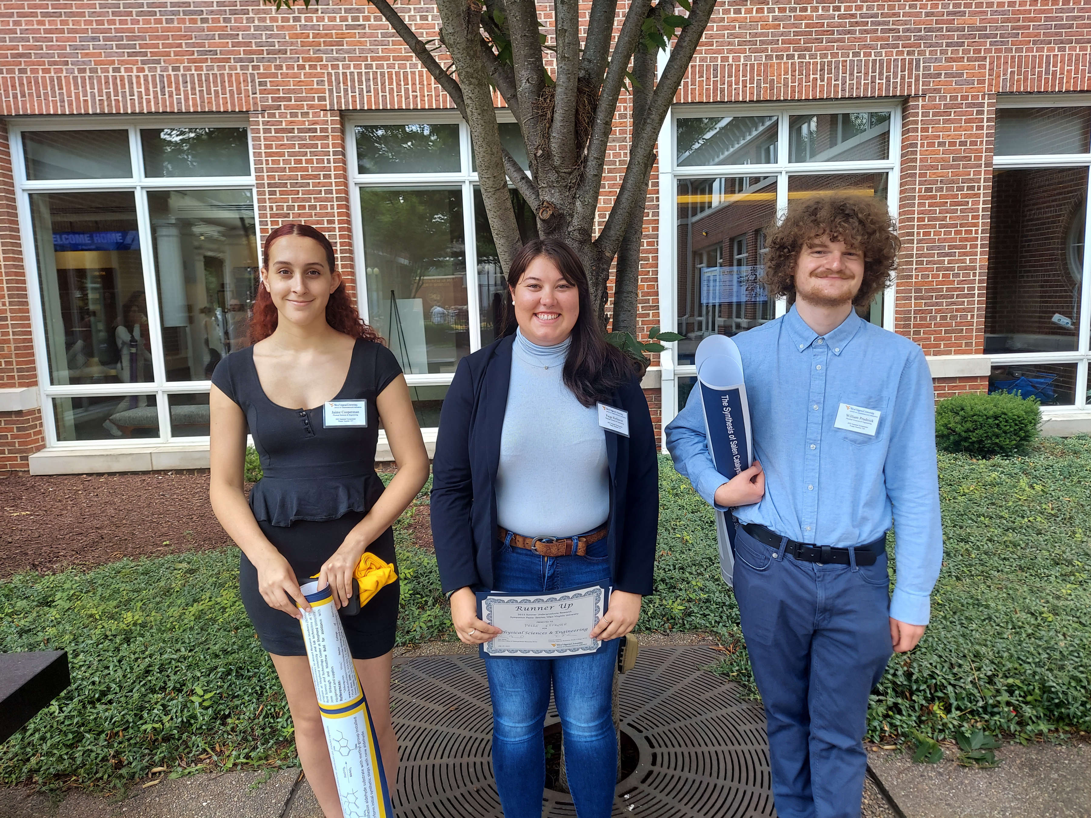 Photo of Jaimie Cooperman, Paige Kefauver, and William Prudnick standing in front of building and tree.