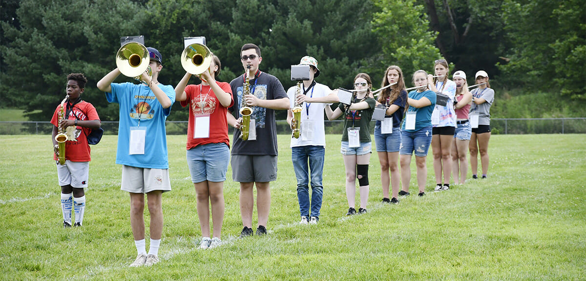 Members of the Washington High School band horn section practicing on intramural field. 