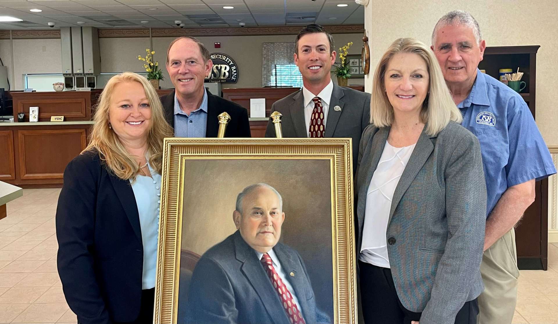 Photo of Jefferson Security Bank and Shepehrd University Foundation personnel standing around Bill Knode portrait.