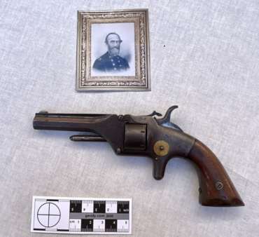 Small pistol beneath copy of image of surgeon Charles Thacher