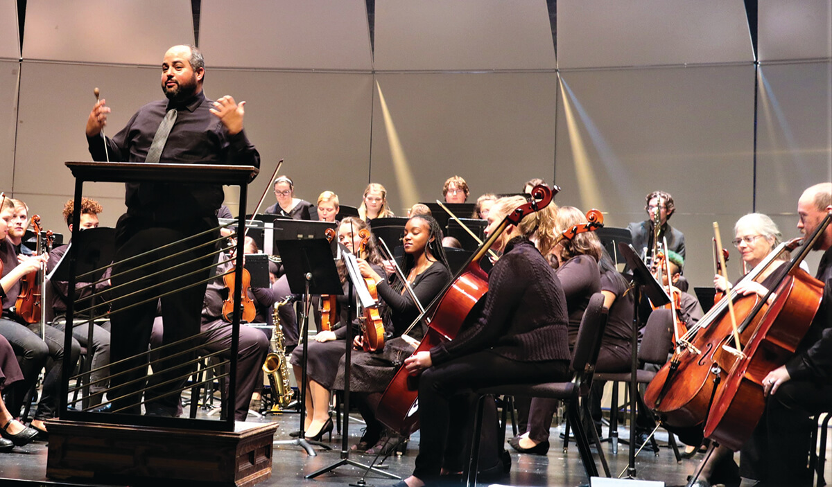 a photo of the community orchestra researsing in the Frank Arts Center McCoy Rehearsal Hall.