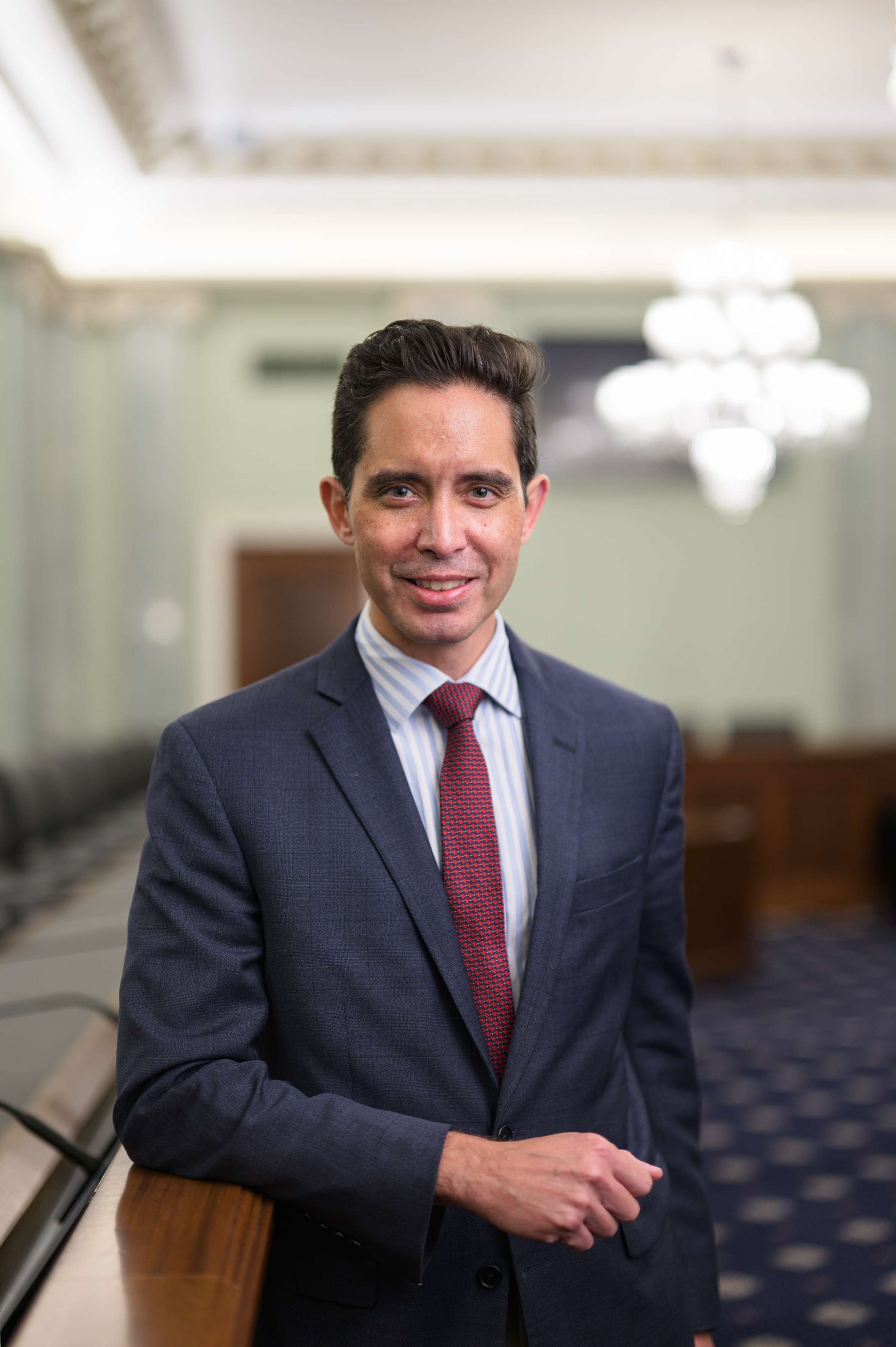 Photo of Roncevert Almond standing in a room in the U.S. Capitol.