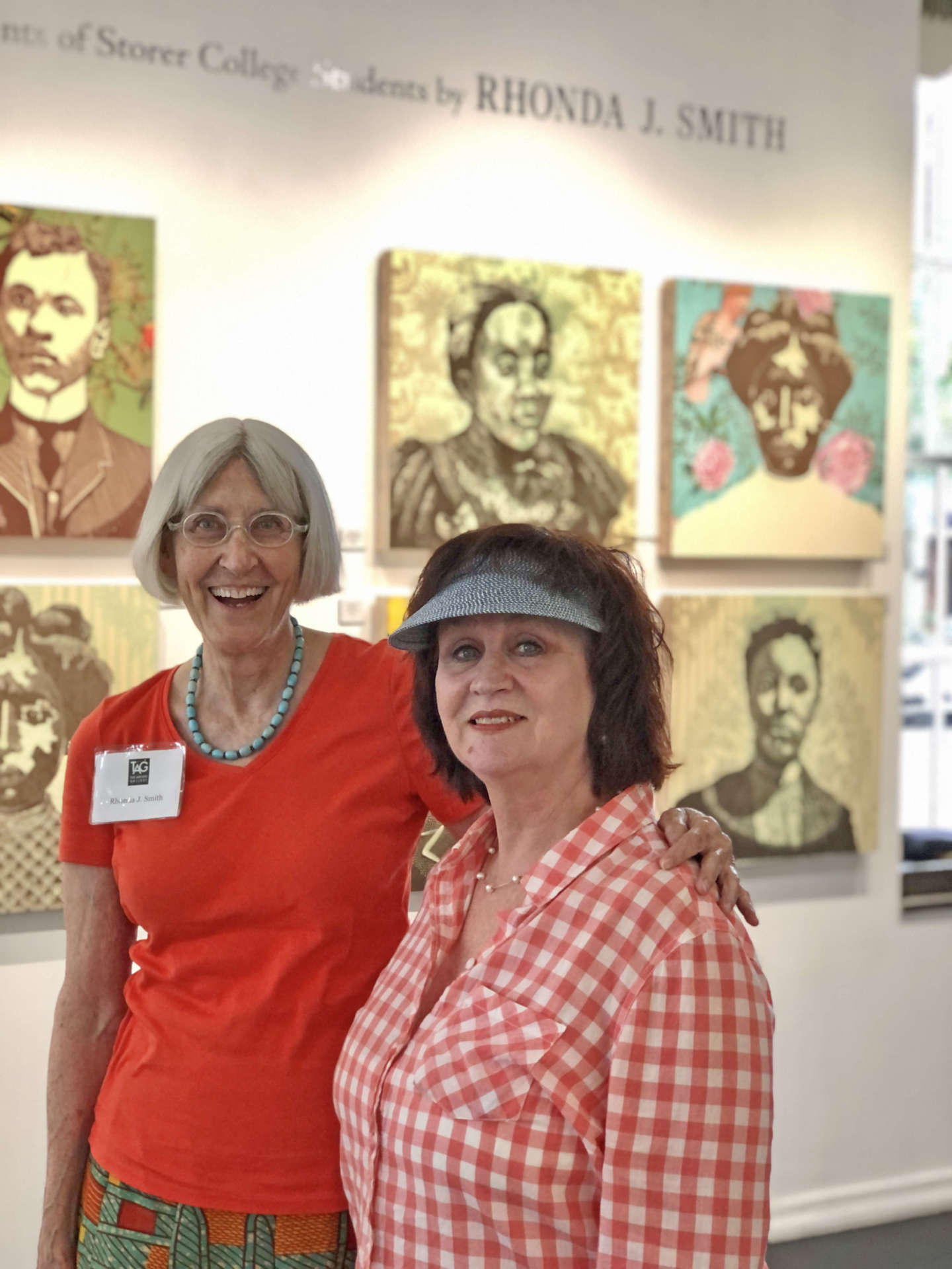 Photo of Rhonda Smith and Dawne Burke standing in front of art exhibit.