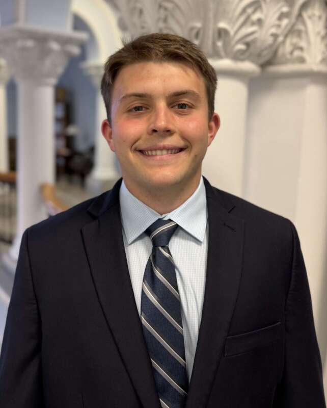 SGA President Tyler Furbee smiling in a suit and tie