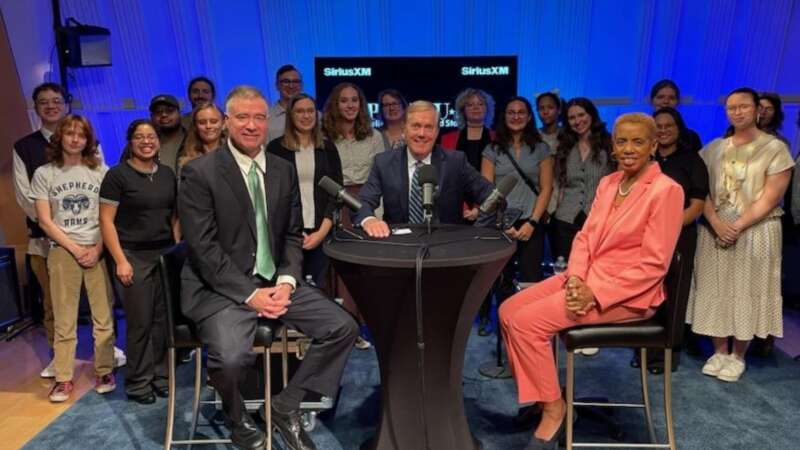 Two congress representatives and a journalist sit at a table in front of a group of Shepherd University students.